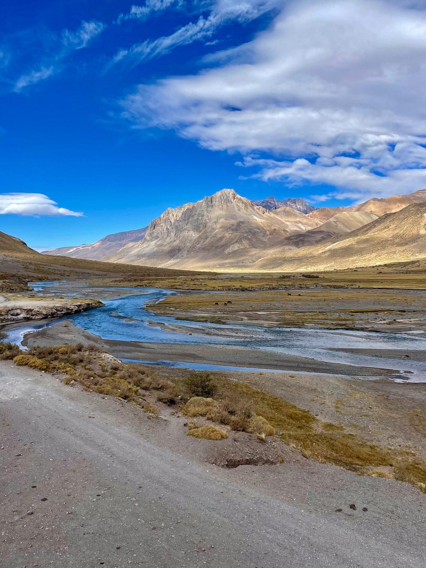 Wide high-altitude river valley near El Sosneado, Malargüe