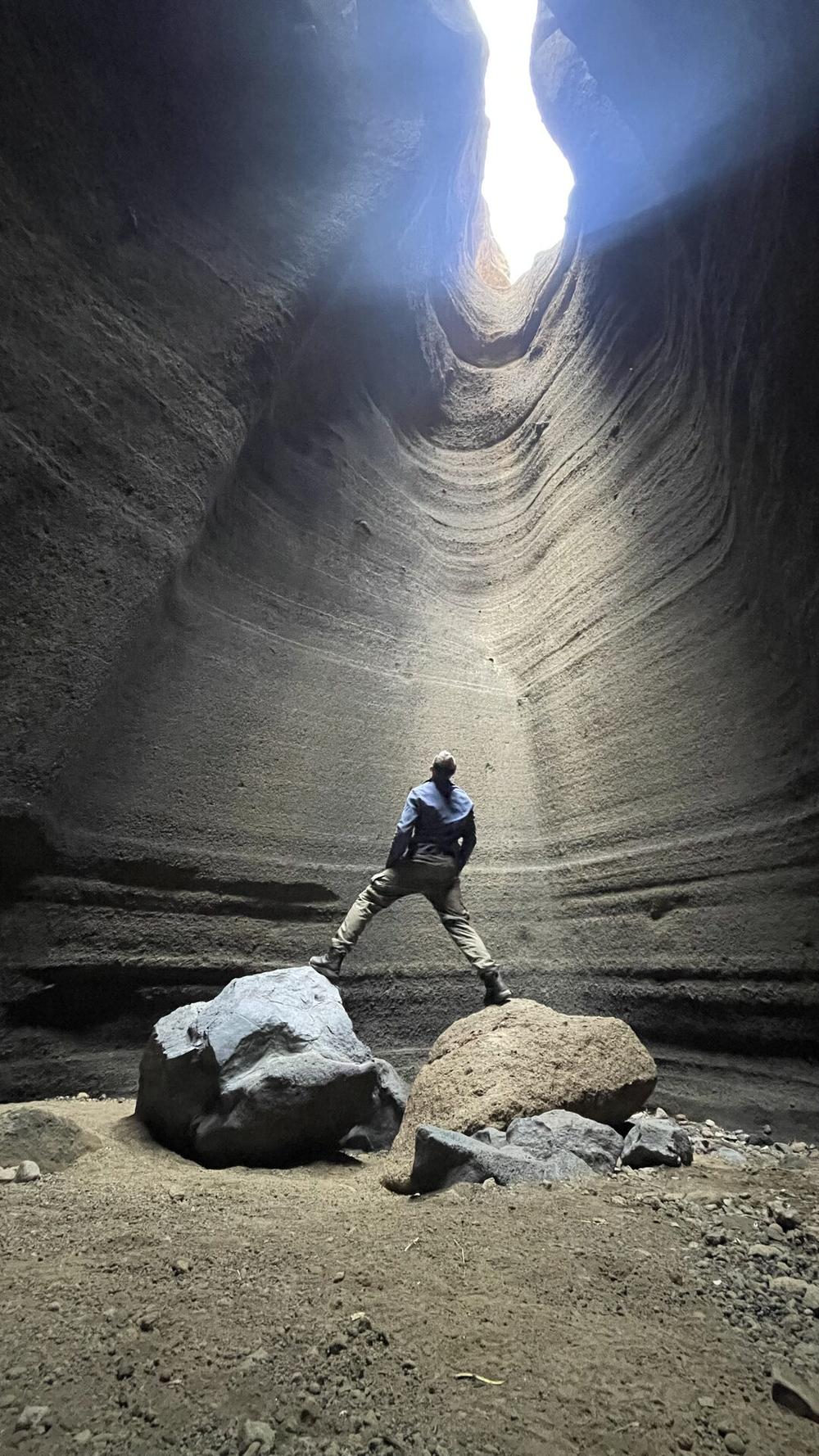 Traveler exploring a sandstone slot canyon near Mendoza