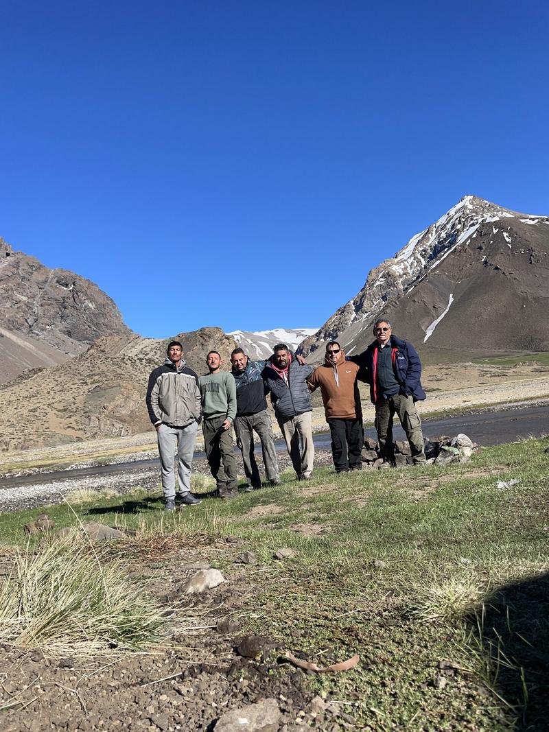 Local guide team standing by the river, high Andes